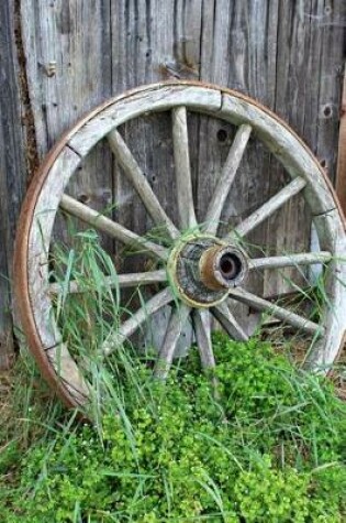 Cover of A Vintage Old Wooden Wagon Wheel Leaning Against a Wall Journal