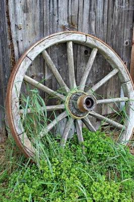 Book cover for A Vintage Old Wooden Wagon Wheel Leaning Against a Wall Journal