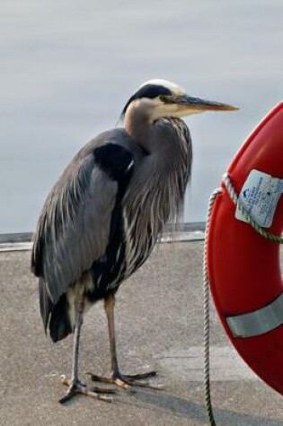 Cover of Cool Blue Heron Bird Standing Near a Red Lifesaving Ring Journal