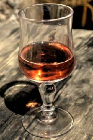 Cover of Glass of Cognac on a Rustic Wood Table