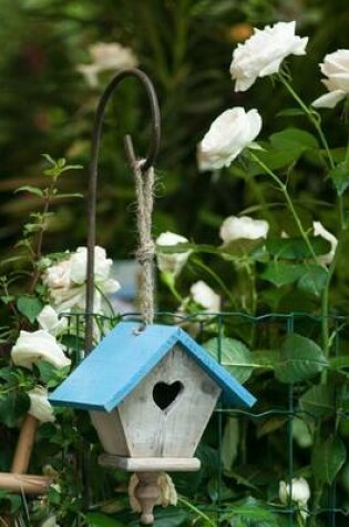 Cover of White Flowers and a Birdhouse with a Blue Roof Journal