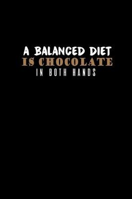 Book cover for A balanced diet is chocolate in both hands