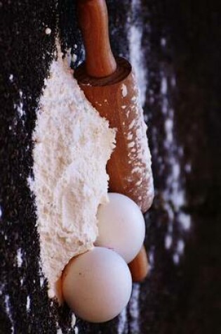 Cover of Flour Dough and a Rolling Pin Ready for Baking